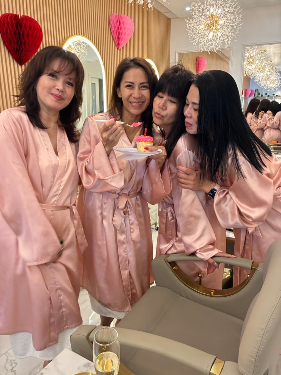 Group of friends celebrating a birthday in pink robes at Lavie Bella Head Spa