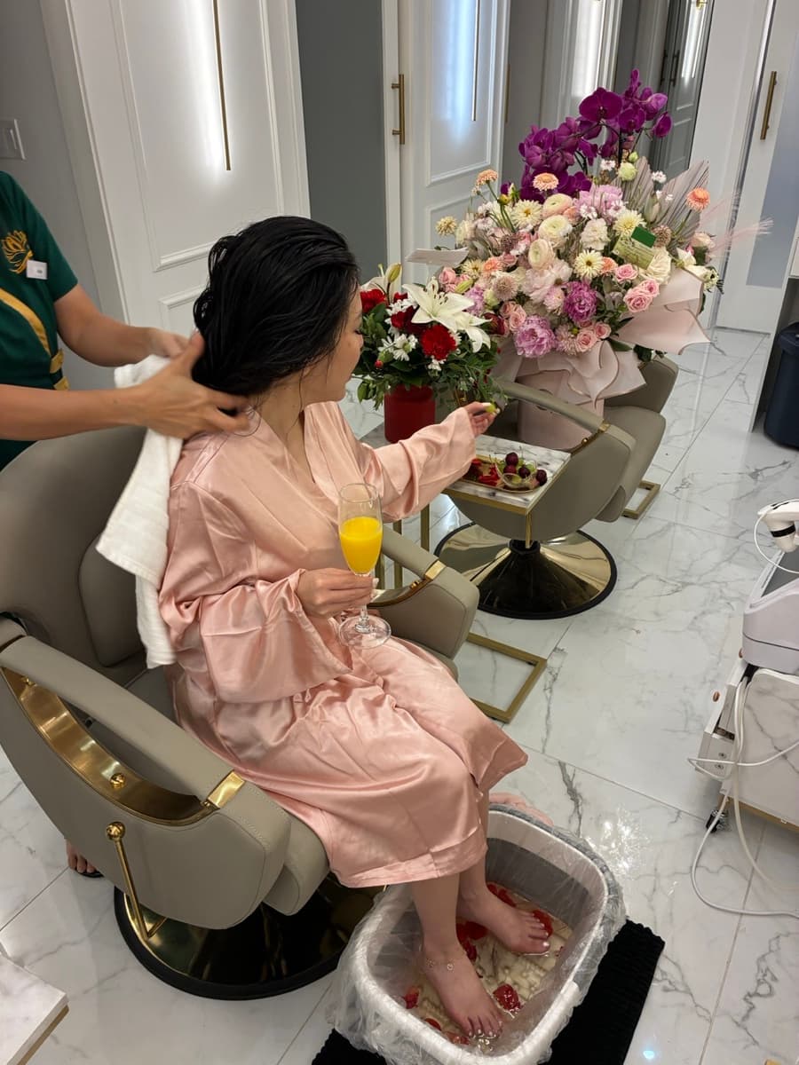 Client in pink robe enjoying mineral foot bath